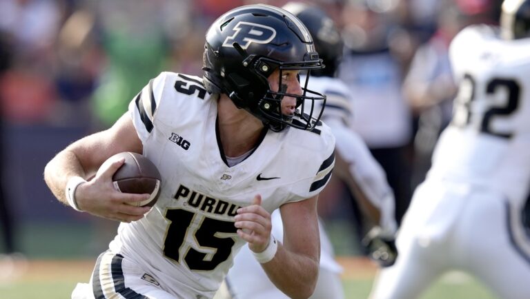Purdue quarterback Ryan Browne carries the ball during the first half of an NCAA college football game against Illinois on Saturday, Oct. 12, 2024, in Champaign, Ill.