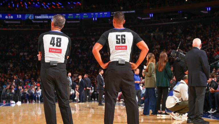 Referees Scott Foster #48 and Mark Ayotte #56 look on during the game on October 13, 2024 at Madison Square Garden in New York City, New York.