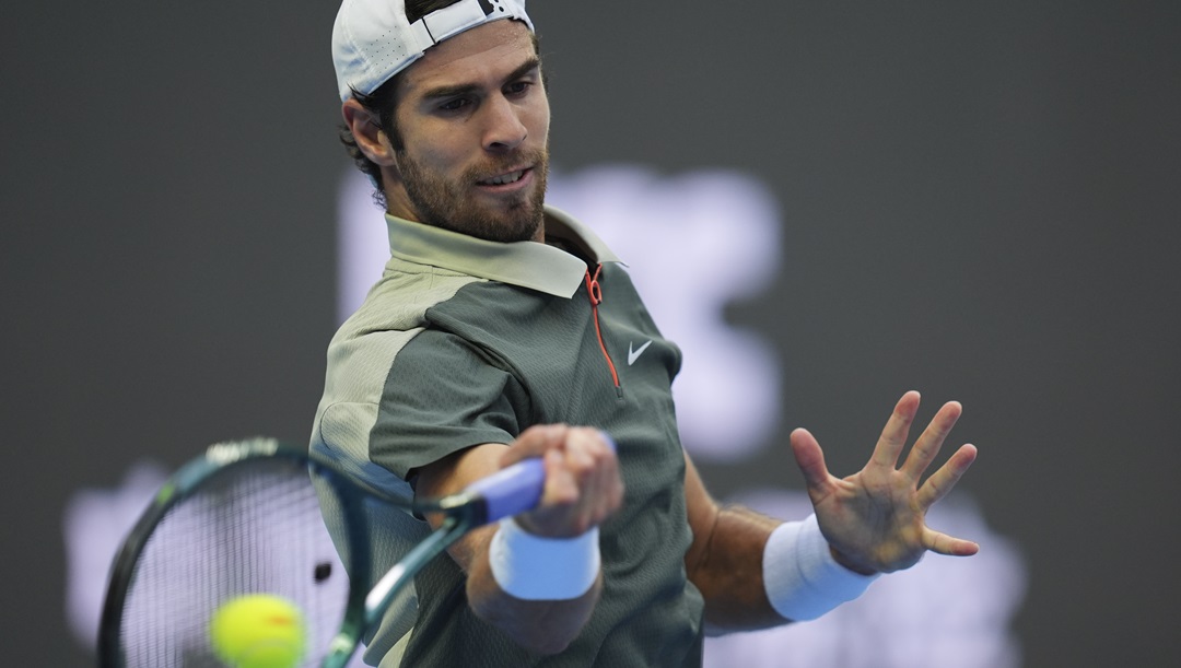 Karen Khachanov of Russia returns a shot from Carlos Alcaraz of Spain during the China Open tennis tournament held at the National Tennis Center in Beijing, Monday, Sept. 30, 2024.