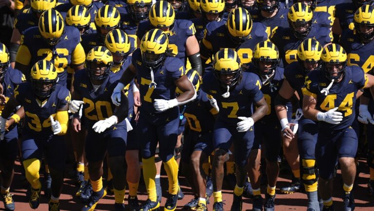 Michigan players run onto the field before an NCAA college football game against Southern California in Ann Arbor, Mich., Saturday, Sept. 21, 2024.