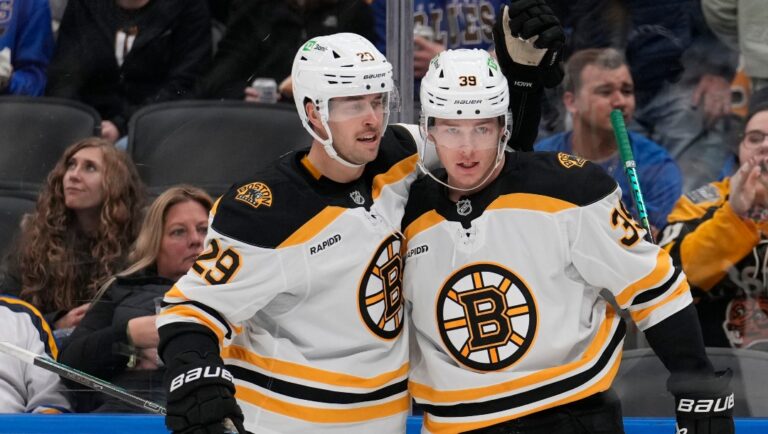 Boston Bruins' Morgan Geekie, right, is congratulated by Parker Wotherspoon (29) after scoring during the third period of an NHL hockey game against the St. Louis Blues Tuesday, Nov. 12, 2024, in St. Louis.