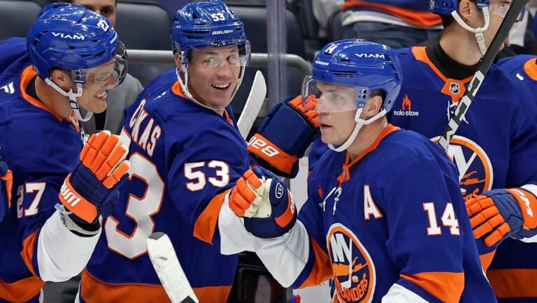 New York Islanders center Bo Horvat (14) celebrates with teammates after scoring a goal during a shootout in an NHL hockey game against the Pittsburgh Penguins Tuesday, Nov. 5, 2024, in Elmont, N.Y. The Islanders won 4-3 in a shootout. (AP Photo/Adam Hunger)