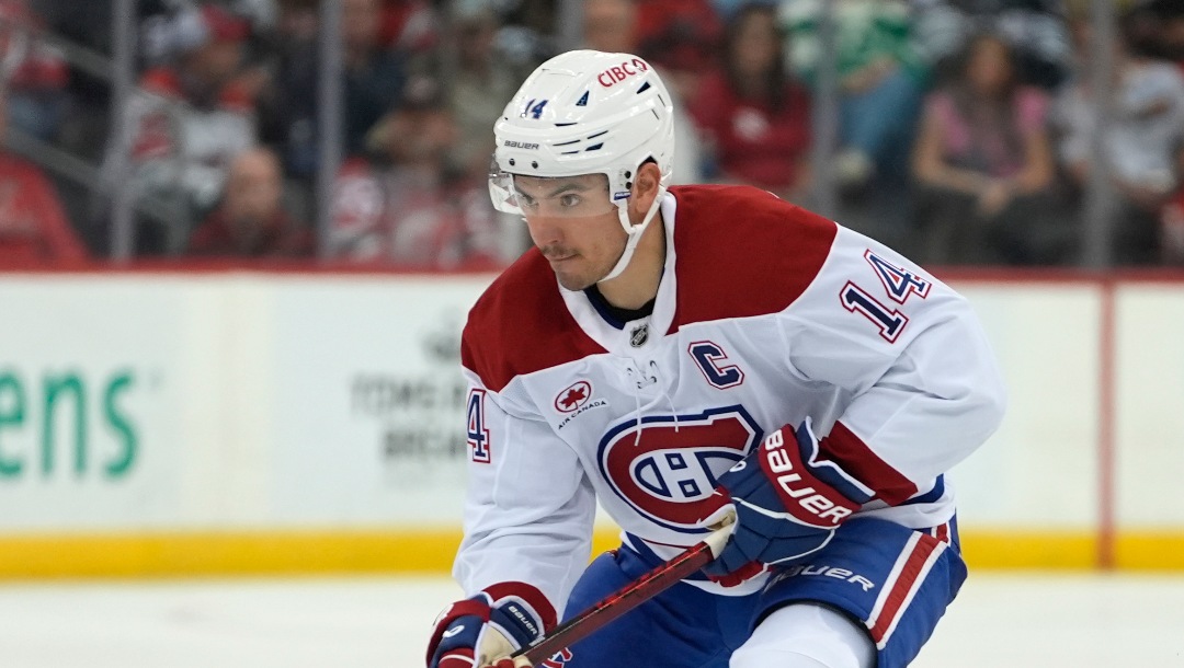 Montréal Canadiens' Nick Suzuki skates with the puck during the first period of an NHL hockey game against the New Jersey Devils, Thursday, Nov. 7, 2024, in Newark, N.J. (AP Photo/Pamela Smith)