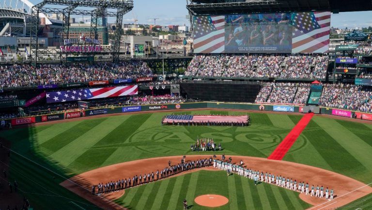 The All-Star Game logo is seen on the field at T-Mobile Park during the national anthem before the baseball game in Seattle, Tuesday, July 11, 2023.