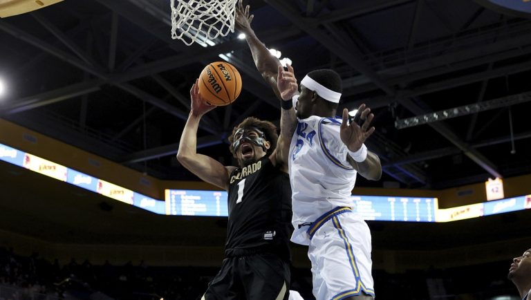Colorado guard J'Vonne Hadley (1) lays up the ball against UCLA forward Adem Bona, center right, during the first half of an NCAA college basketball game Thursday, Feb. 15, 2024, in Los Angeles.