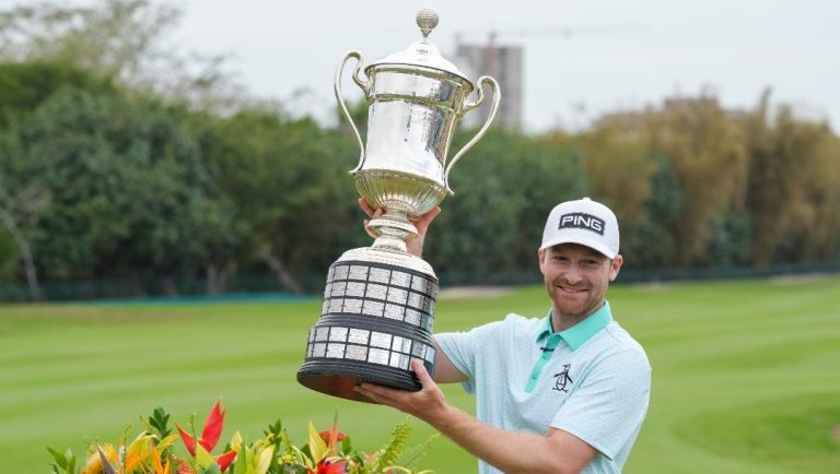 Brian Campbell, of the United States, holds the championship trophy after the final round of the Mexico Open golf tournament in Puerto Vallarta, Mexico, Sunday, Feb. 23, 2025.