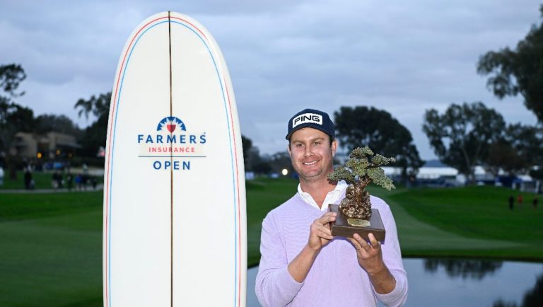 Harris English holds up the trophy after winning the Farmers Insurance Open golf tournament at Torrey Pines Saturday, Jan. 25, 2025, in San Diego.