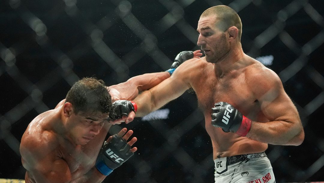 Sean Strickland, right, punches Brazil's Paulo Costa during the fourth round of a middleweight bout at the UFC 302.