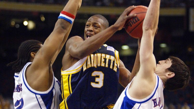 Marquette's Dwyane Wade (3) tries to drive between Kansas defenders Jeff Graves, left, and Kirk Hinrich in the first half of their semifinal game at the Final Four on Saturday, April 5, 2003, in New Orleans.
