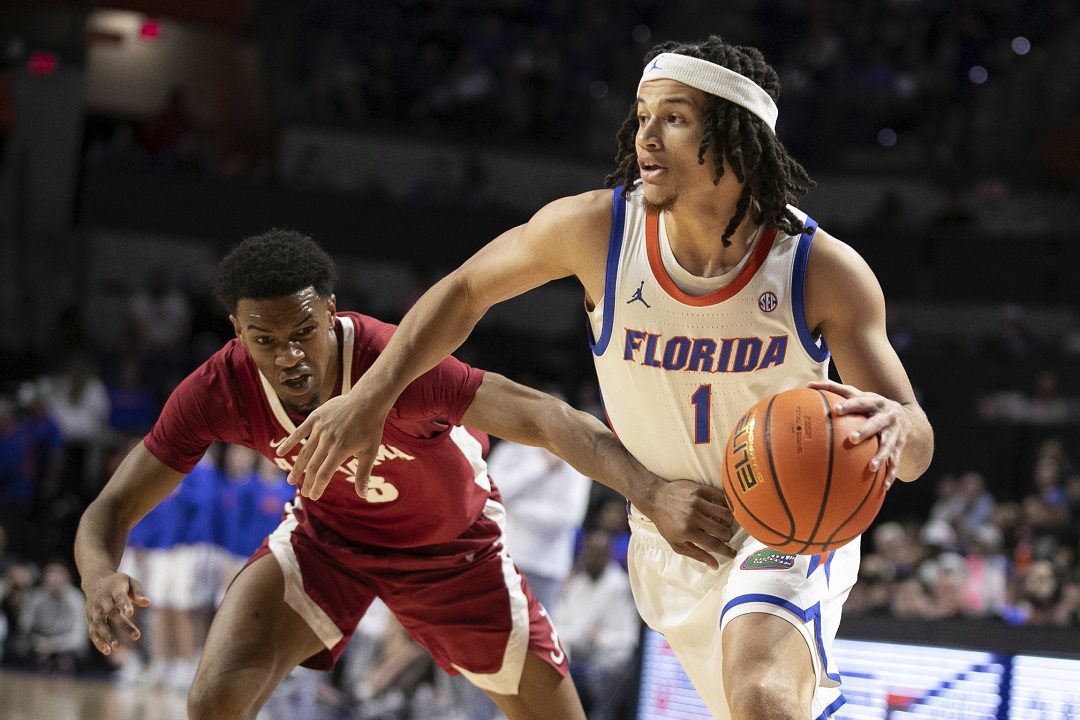 Florida guard Walter Clayton Jr. (1) gets by Alabama guard Rylan Griffen (3) during the first half of an NCAA college basketball game Tuesday, March 5, 2024, in Gainesville, Fla.