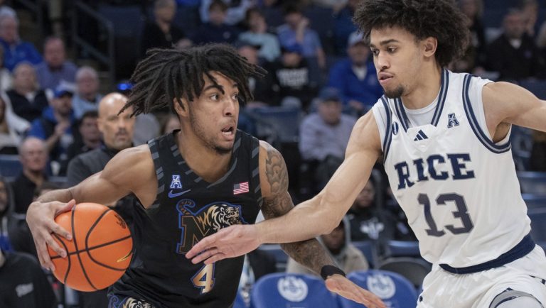 Memphis guard PJ Haggerty (4) drives with the ball defended by Rice forward Andrew Akuchie (13) during the first half of an NCAA college basketball game, Wednesday, Feb. 26, 2025, in Memphis, Tenn.