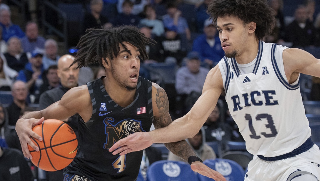 Memphis guard PJ Haggerty (4) drives with the ball defended by Rice forward Andrew Akuchie (13) during the first half of an NCAA college basketball game, Wednesday, Feb. 26, 2025, in Memphis, Tenn.
