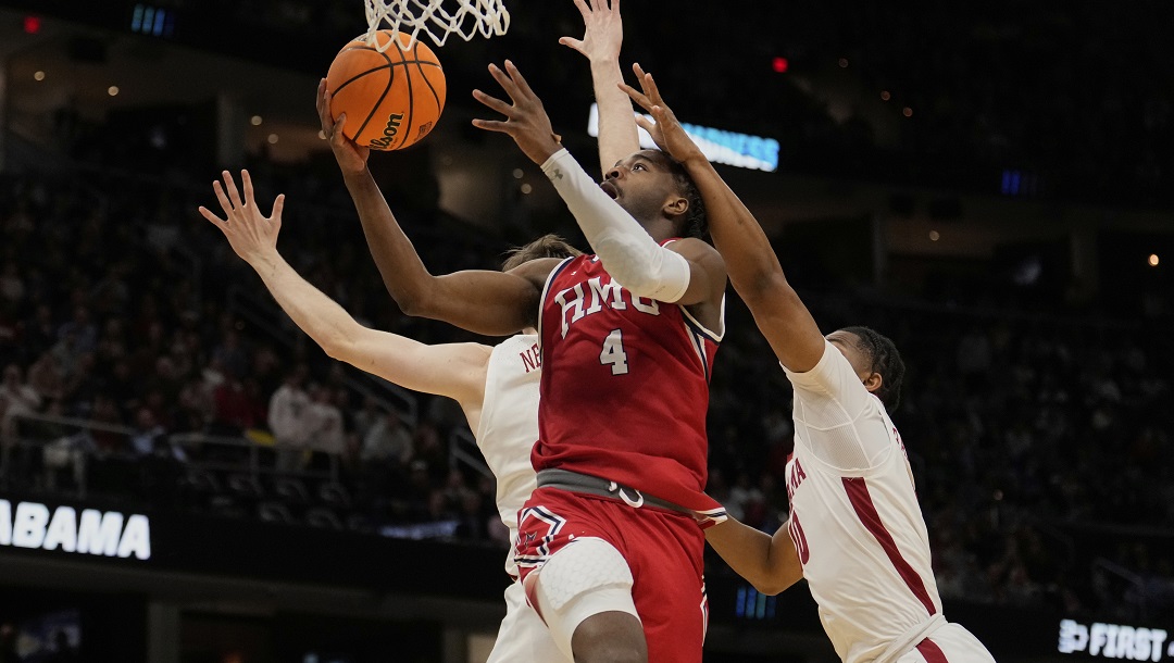 Robert Morris guard Josh Omojafo (4) shoots between Alabama forward Grant Nelson, left, and guard Labaron Philon, right, in the second half in the first round of the NCAA college basketball tournament, Friday, March 21, 2025, in Cleveland.