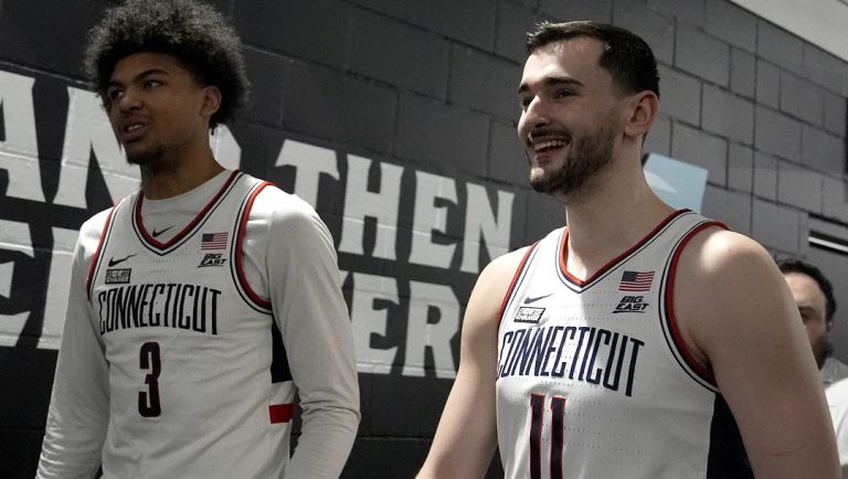 UConn forward Alex Karaban (11) and forward Jaylin Stewart exit the interview room ahead of a Final Four college basketball game in the NCAA Tournament, Thursday, April 4, 2024, in Glendale, Ariz. UConn will face Alabama on Saturday.