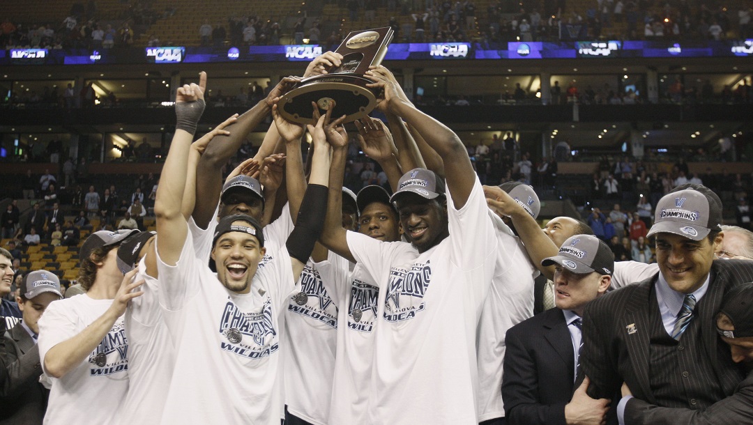 Villanova players celebrate with the trophy after defeating Pittsburgh, 78-76 during a men's NCAA tournament regional championship college basketball game in Boston, Saturday, March 28, 2009. Villanova advances to the Final Four.