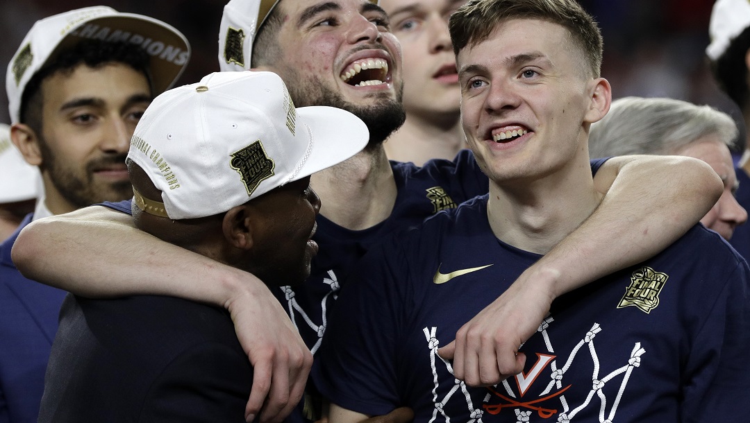Virginia's Ty Jerome, center, and Kyle Guy, right, celebrate after defeating Texas Tech 85-77 in the overtime in the championship of the Final Four NCAA college basketball tournament, Monday, April 8, 2019, in Minneapolis. Jerome said the Cavaliers needed time to regroup from the UMBC loss but grew stronger as a result in their push to the national title the following year.