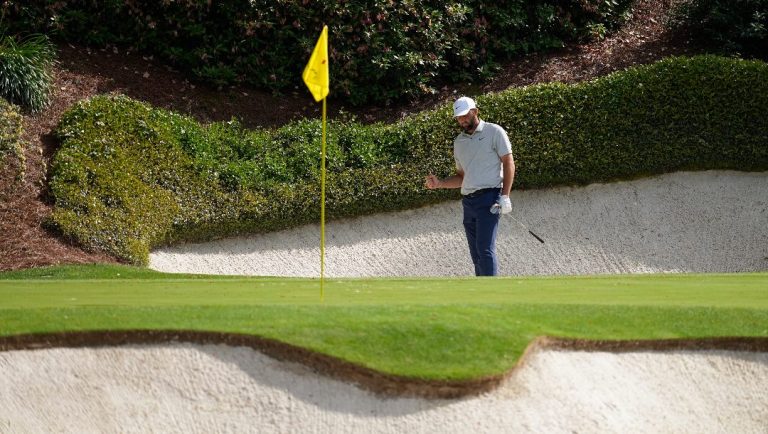 Scottie Scheffler celebrates after a birdie from the bunker on the 12th hole during the first round at the Masters golf tournament at Augusta National Golf Club Thursday, April 11, 2024, in Augusta, Ga.