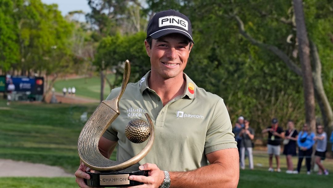 Viktor Hovland, of Norway, poses the with the trophy after winning the Valspar Championship golf tournament Sunday, March 23, 2025, at Innisbrook in Palm Harbor, Fla.