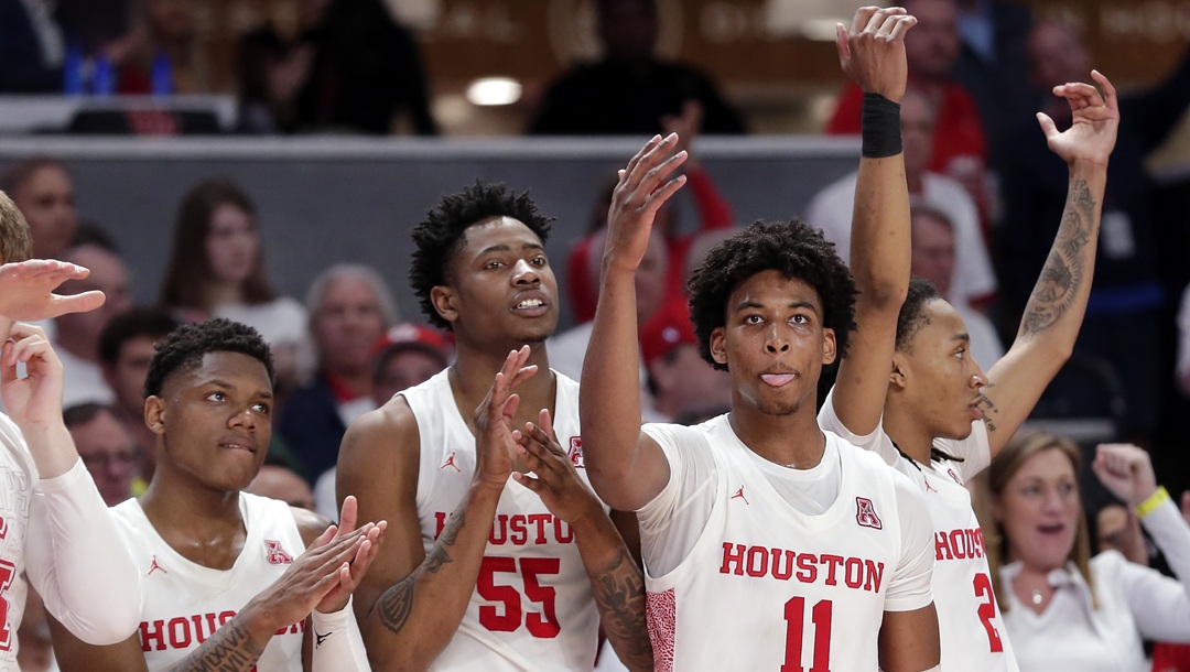 Houston players, from left, Marcus Sasser (0),Brison Gresham (55), Nate Hinton (11) and Caleb Mills (2) celebrate their win against Cincinnati the the end of the second half of an NCAA college basketball game Sunday, March 1, 2020, in Houston.