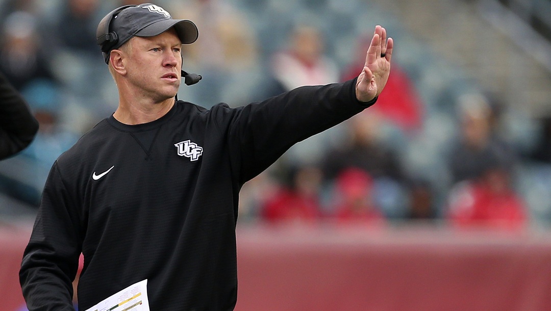 In this Saturday, Nov. 18, 2017, file photo, Central Florida head coach Scott Frost signals to his team during the third quarter of an NCAA college football game against Temple in Philadelphia. Frost and nine of his assistants will be full-time Nebraska employees immediately after the Peach Bowl game against Auburn on Monday, Jan. 1, 2018. Until then, they’ve worked almost nonstop to make sure the Central Florida players feel no disruption in their normal practice-day schedules.