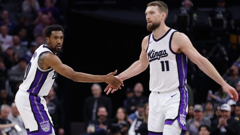 SACRAMENTO, CALIFORNIA - MARCH 27: Malik Monk #0 and Domantas Sabonis #11 of the Sacramento Kings react after a play in the third quarter against the Portland Trail Blazers at Golden 1 Center on March 27, 2025 in Sacramento, California.