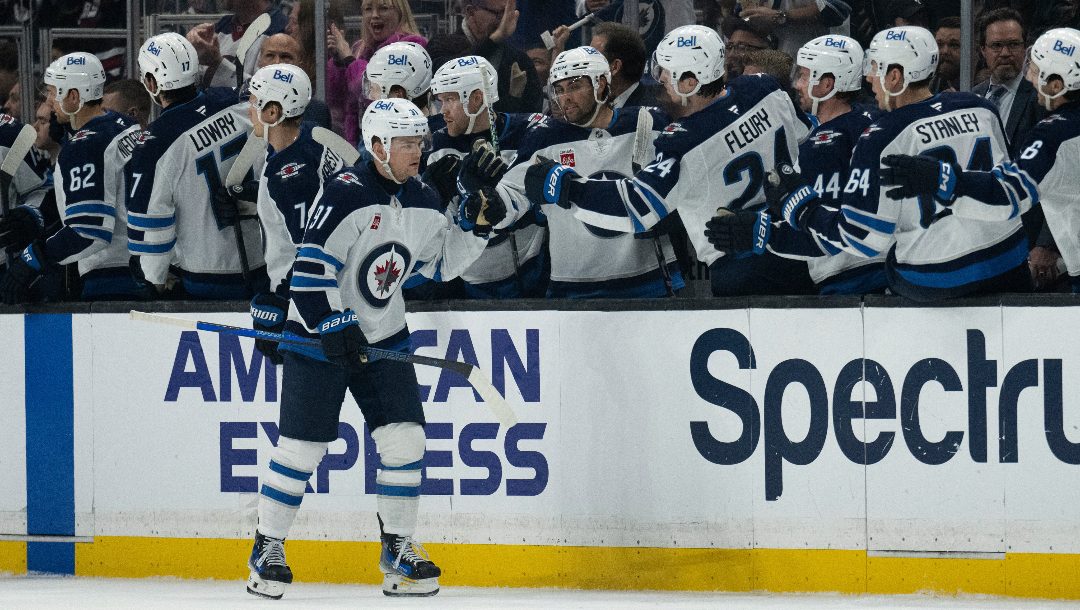 Winnipeg Jets center Cole Perfetti (91) celebrates his goal with the bench during the second period of an NHL hockey game against the Los Angeles Kings, Tuesday, April 1, 2025, in Los Angeles.