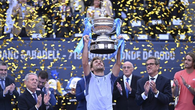 Casper Ruud of Norway lifts the trophy after defeating Stefanos Tsitsipas of Greece, right, 7-5, 6-3 during the final of the Barcelona Open tennis tournament in Barcelona, Spain, Sunday, April 21, 2024.