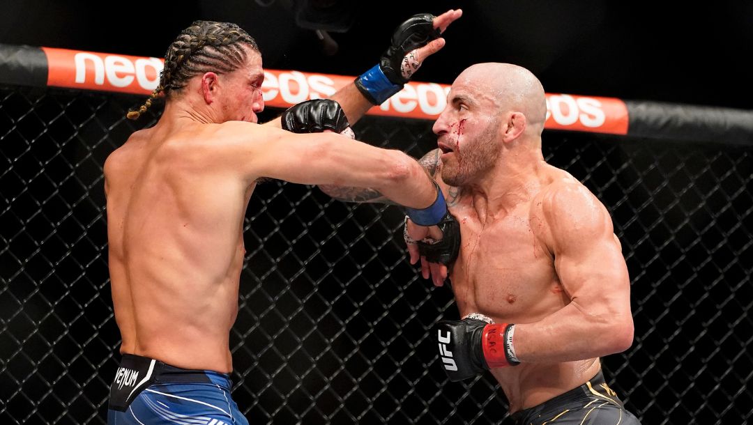 Alexander Volkanovski, right, throws punches against Brian Ortega during a featherweight mixed martial arts title bout at UFC 266.