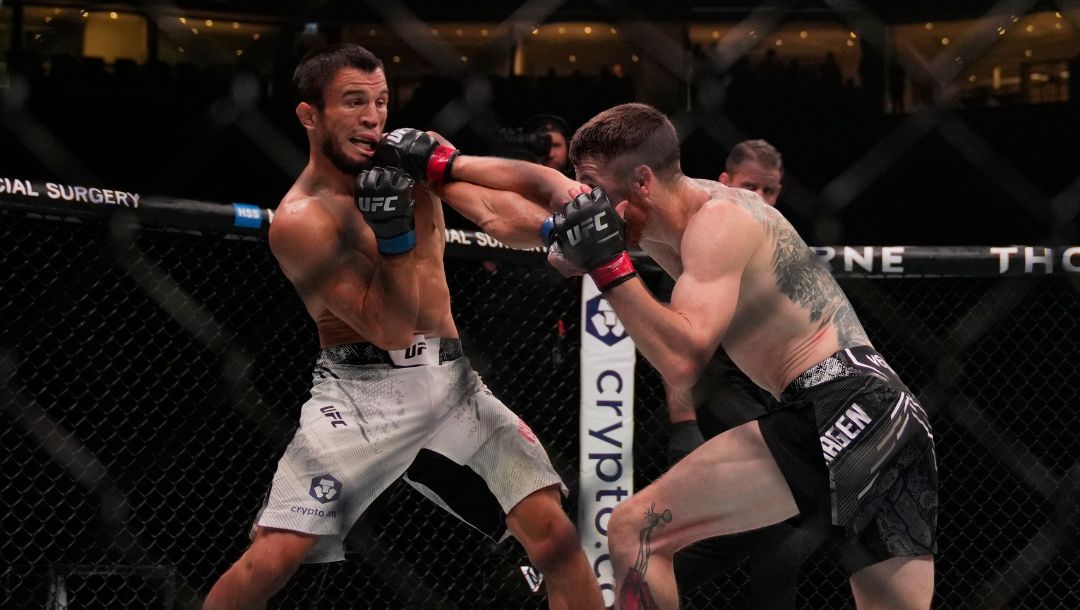 Russia's Umar Nurmagomedov, left, fights with Cory Sandhagen, right, of the United States, during a bantamweight mixed martial.