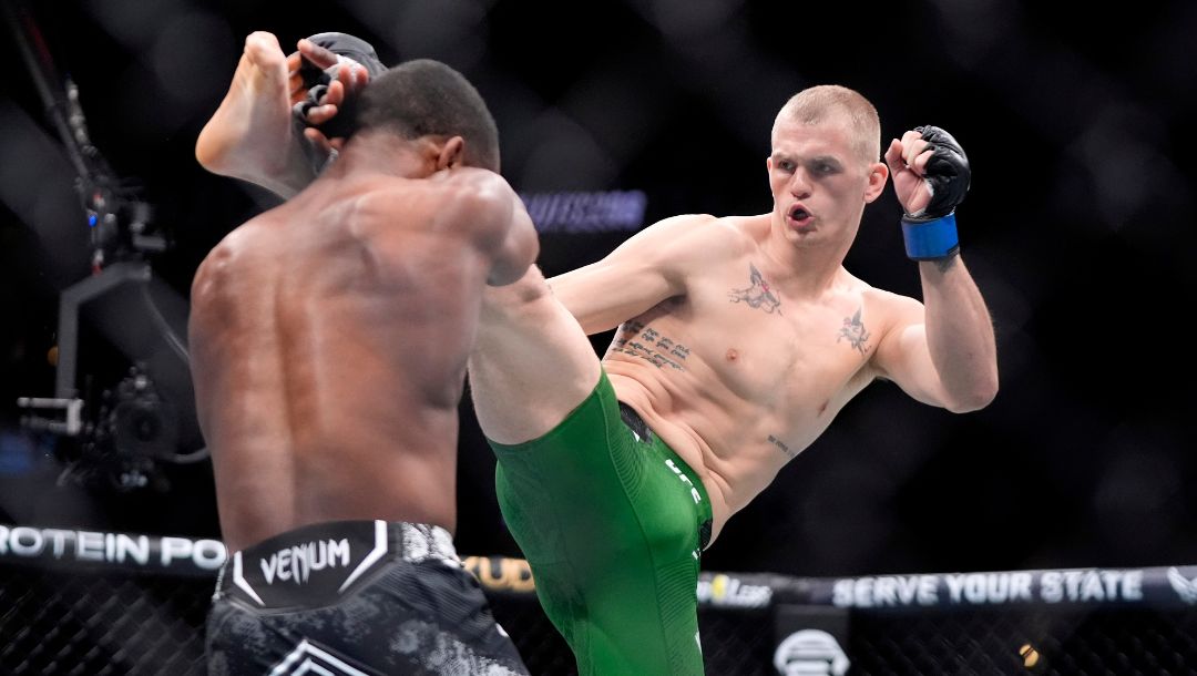 Ian Machado Garry, right, throws a kick to Geoff Neal during their welterweight bout at the UFC 298 mixed martial arts event.