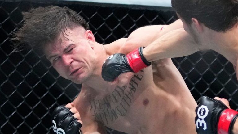 Russia's Movsar Evloev, right, punches Brazil's Diego Lopes during the third round of a featherweight bout at the UFC 288.
