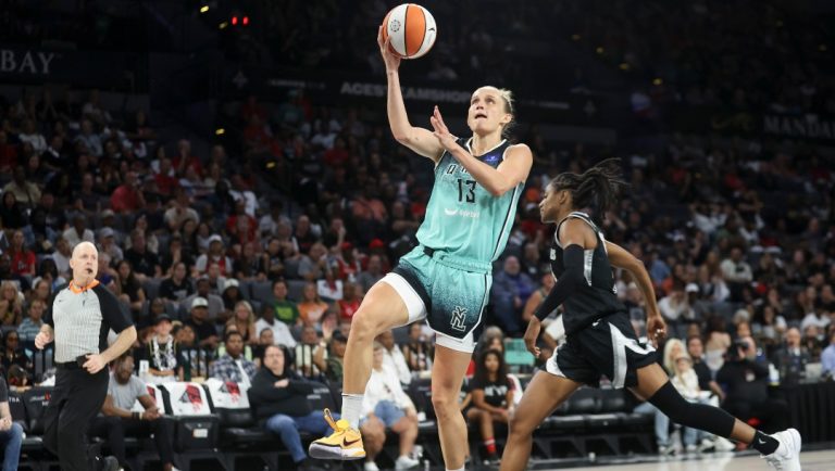 New York Liberty forward Leonie Fiebich (13) goes up for a basket past Las Vegas Aces guard Tiffany Hayes (15) during the second half of a WNBA Semifinal basketball game Sunday, Oct. 6, 2024, in Las Vegas.