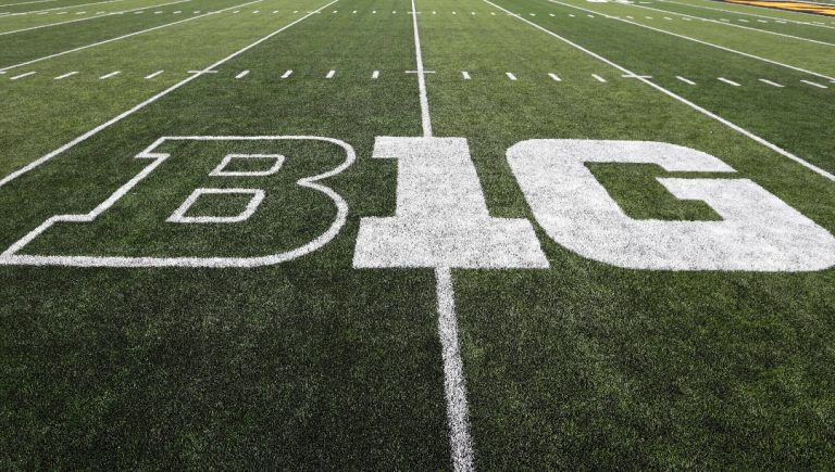 FILE - The Big Ten logo is displayed on the field before an NCAA college football game between Iowa and Miami of Ohio in Iowa City, Iowa., Aug. 31, 2019. The Power Five is now a Power Four, but within that there is a Big Two. The Big Ten and SEC now have media rights deals that will allow them to provide yearly payouts to their members of upwards of $70 million. (AP Photo/Charlie Neibergall, File)