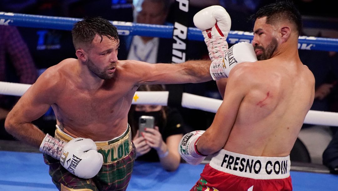 Josh Taylor hits Jose Ramirez during a junior welterweight title boxing bout Saturday, May 22, 2021, in Las Vegas.