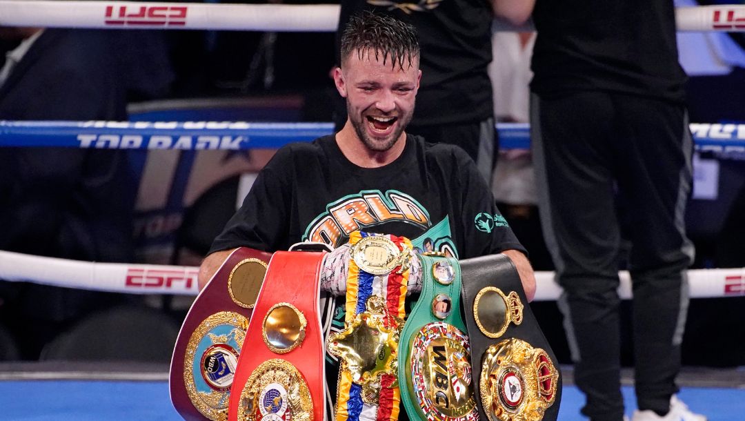 FILE - Josh Taylor celebrates while holding his belts after defeating Jose Ramirez by unanimous decision in a junior welterweight.