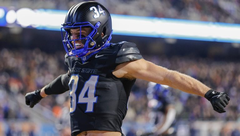Boise State safety Alexander Teubner (34) hypes up the home crowd after running on to the field before their matchup with Nevada in a NCAA college football game, Saturday, Nov. 9, 2024, in Boise, Idaho. Boise State won 28-21.