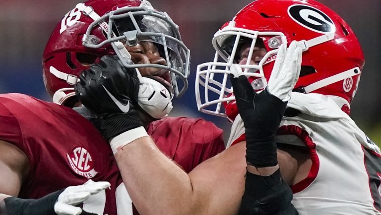 Georgia offensive lineman Warren Ericson (50) and Alabama wide receiver Slade Bolden (18) play during the second half of the Southeastern Conference championship NCAA college football game, Saturday, Dec. 4, 2021, in Atlanta. Those Georgia Bulldogs aren't the only ones having a devil of a time beating fellow Southeastern Conference powerhouse Alabama. They're just the only one that gets another shot in the biggest game of them all.