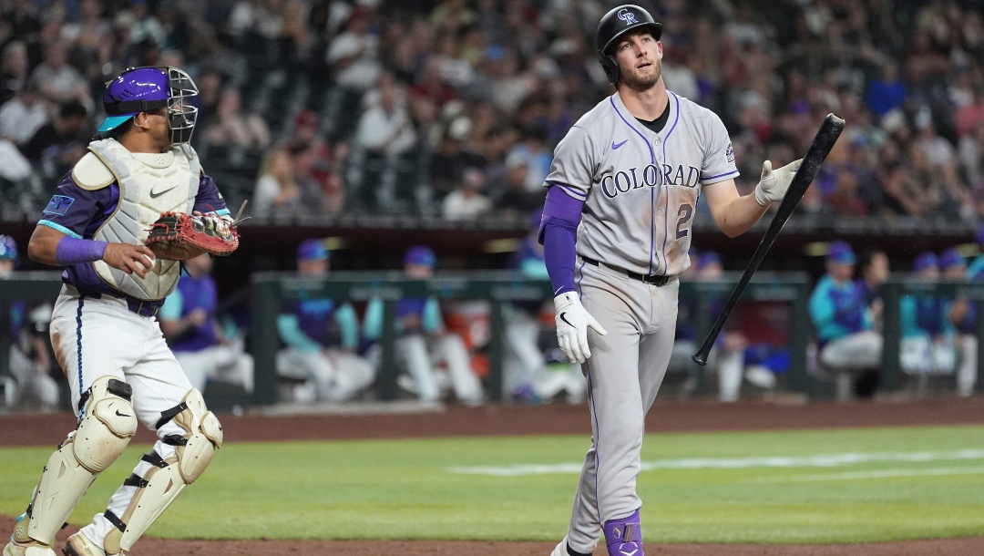 Colorado Rockies' Ryan McMahon, right, flips his bat after striking out as Arizona Diamondbacks catcher Gabriel Moreno, left, hold the ball during the ninth inning of a baseball game Friday, May 16, 2025, in Phoenix.