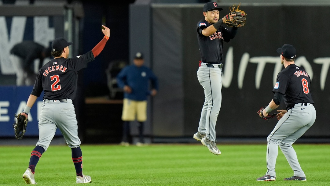 Cleveland Guardians outfielders Tyler Freeman, left, Steven Kwan, center, and Lane Thomas celebrate after a baseball game against the New York Yankees at Yankee Stadium Tuesday, Aug. 20, 2024, in New York. The Guardians defeated the Yankees in extra innings 9-5.