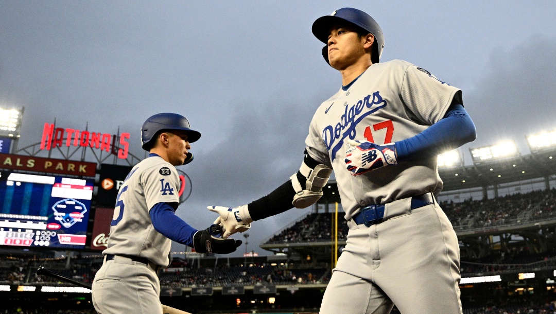 Los Angeles Dodgers designated hitter Shohei Ohtani (17) celebrates with Tommy Edman, left, after his two-run home run during the third inning of a baseball game against the Washington Nationals, Monday, April 7, 2025, in Washington.