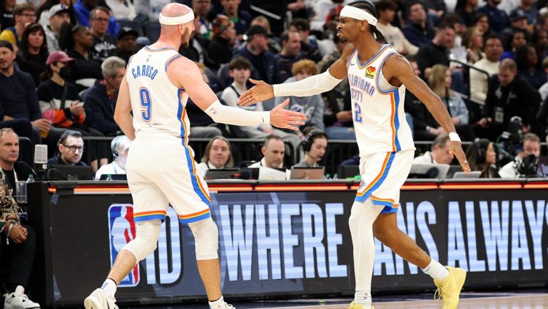 MINNEAPOLIS, MINNESOTA - FEBRUARY 23: Alex Caruso #9 and Shai Gilgeous-Alexander #2 of the Oklahoma City Thunder celebrate against the Minnesota Timberwolves in the third quarter at Target Center on February 23, 2025 in Minneapolis, Minnesota. The Thunder defeated the Timberwolves 130-123.
