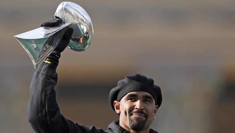 Philadelphia Eagles quarterback Jalen Hurts holds up the Lombardi trophy as he speaks during the team's NFL football Super Bowl 59 parade and celebration, Friday, Feb. 14, 2025, in Philadelphia.