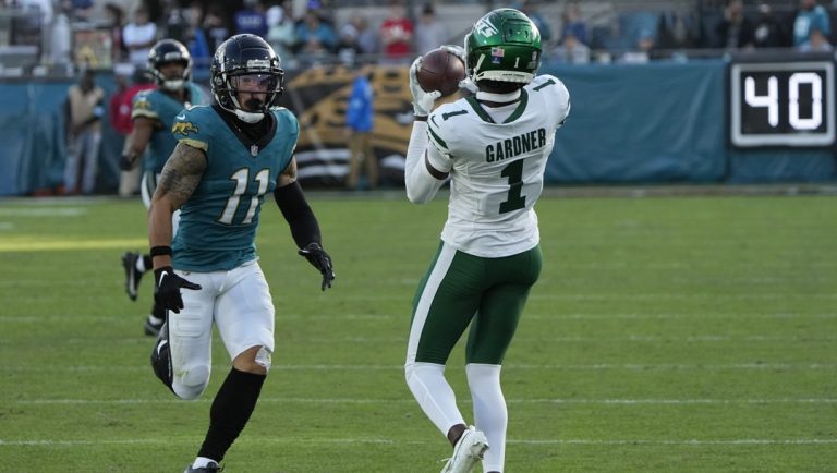 New York Jets cornerback Sauce Gardner (1) intercepts a pass intended for Jacksonville Jaguars wide receiver Parker Washington (11) during the second half of an NFL football game Sunday, Dec. 15, 2024, in Jacksonville, Fla.