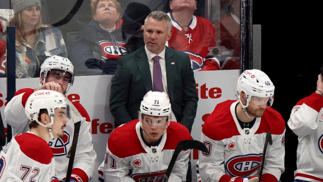 Montreal Canadiens coach Martin St. Louis, center top, watches his team during the third period of an NHL hockey game against the Columbus Blue Jackets in Columbus, Ohio, Monday, Dec. 23, 2024.
