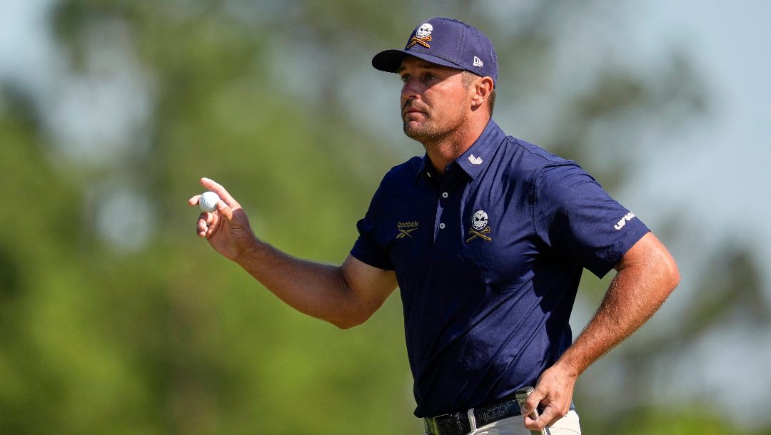 Bryson DeChambeau waves after making a putt on the eighth hole during the final round at the Masters golf tournament, Sunday, April 13, 2025, in Augusta, Ga.