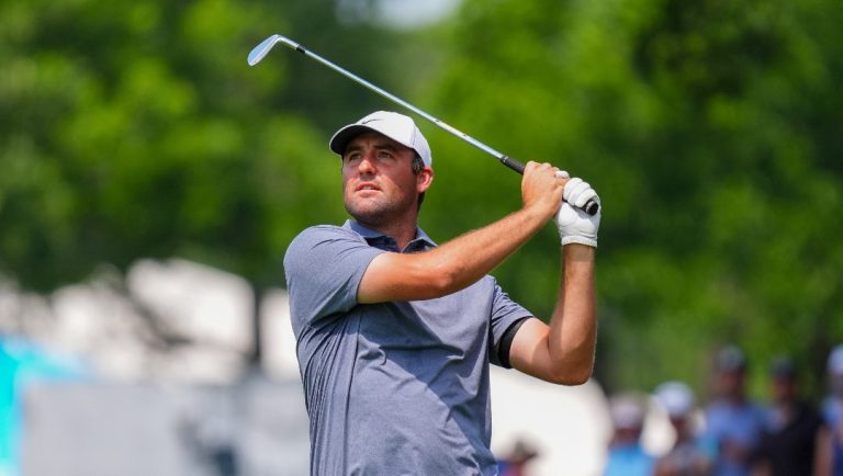 Scottie Scheffler hits a shot on the first hole fairway during the final round of the Charles Schwab Challenge golf tournament at Colonial Country Club in Fort Worth, Texas, Sunday, May 25, 2025.