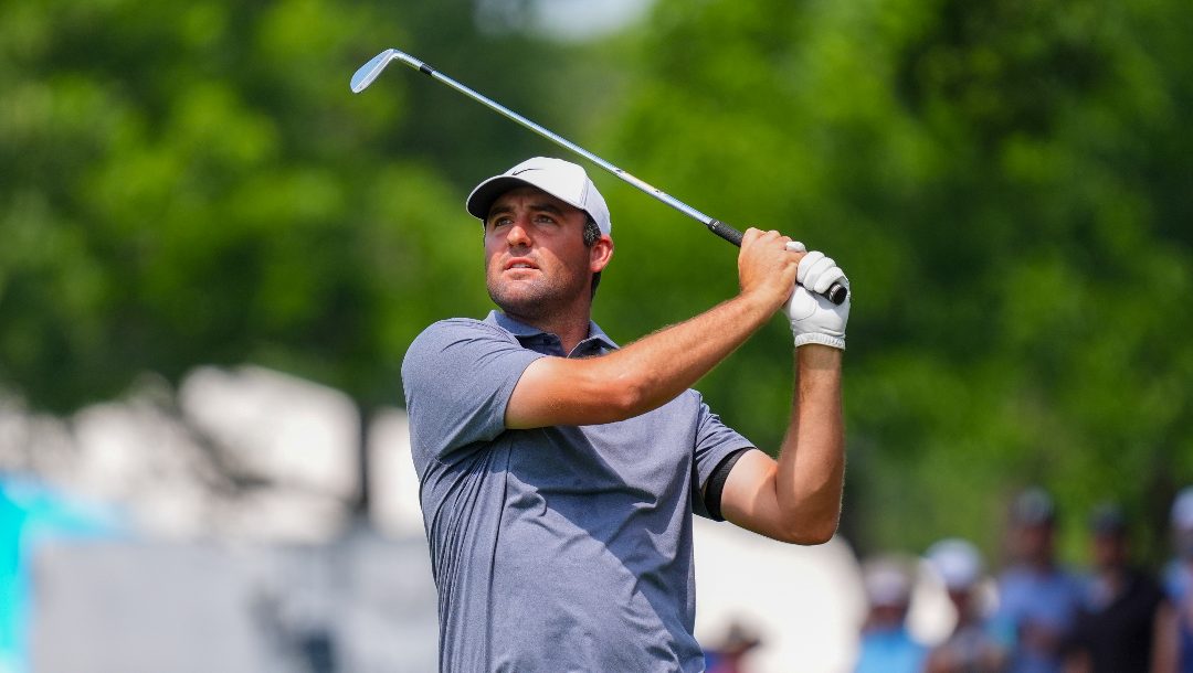 Scottie Scheffler hits a shot on the first hole fairway during the final round of the Charles Schwab Challenge golf tournament at Colonial Country Club in Fort Worth, Texas, Sunday, May 25, 2025.