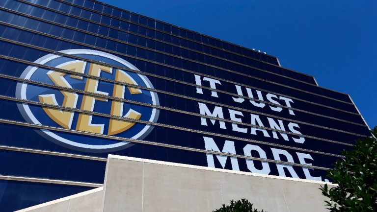 Logos decorate the outside of the Hyatt Regency for the NCAA Southeastern Conference’s annual media gathering, Monday, July 10, 2017, in Hoover, Ala. (AP Photo/Butch Dill)
