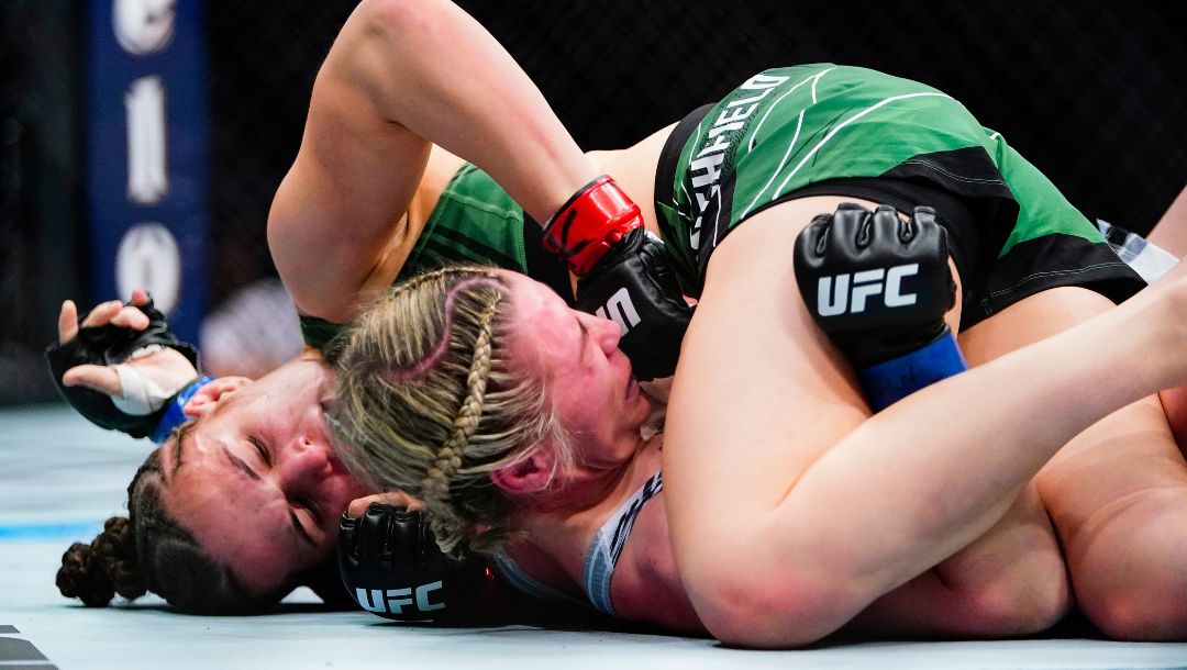 Erin Blanchfield, left, punches England's Molly McCann during the first round of a women's flyweight bout in the UFC 281.