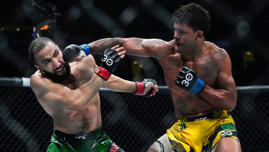 Brazil's Gilbert Burns, right, punches Belal Muhammad during the fifth round of a welterweight bout at the UFC 288.